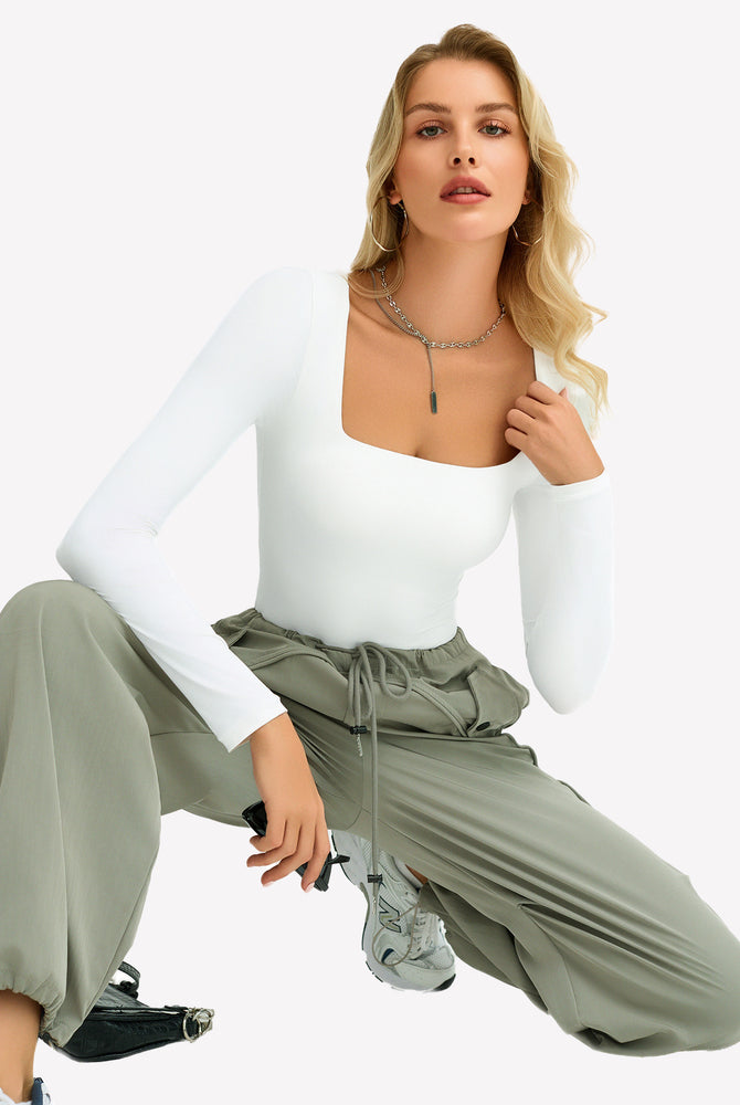 White square neck bodysuit with green cargo pants, ultra-stretchy, shows bodyline.