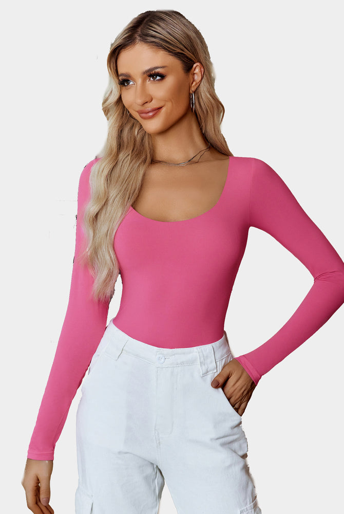 Pink long sleeve scoop neck bodysuit shapewear with white pants, flattering fit