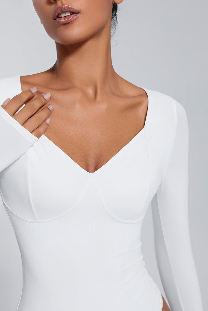 White long sleeve bodysuit with deep V-neck, tummy control shapewear, flattering fit.