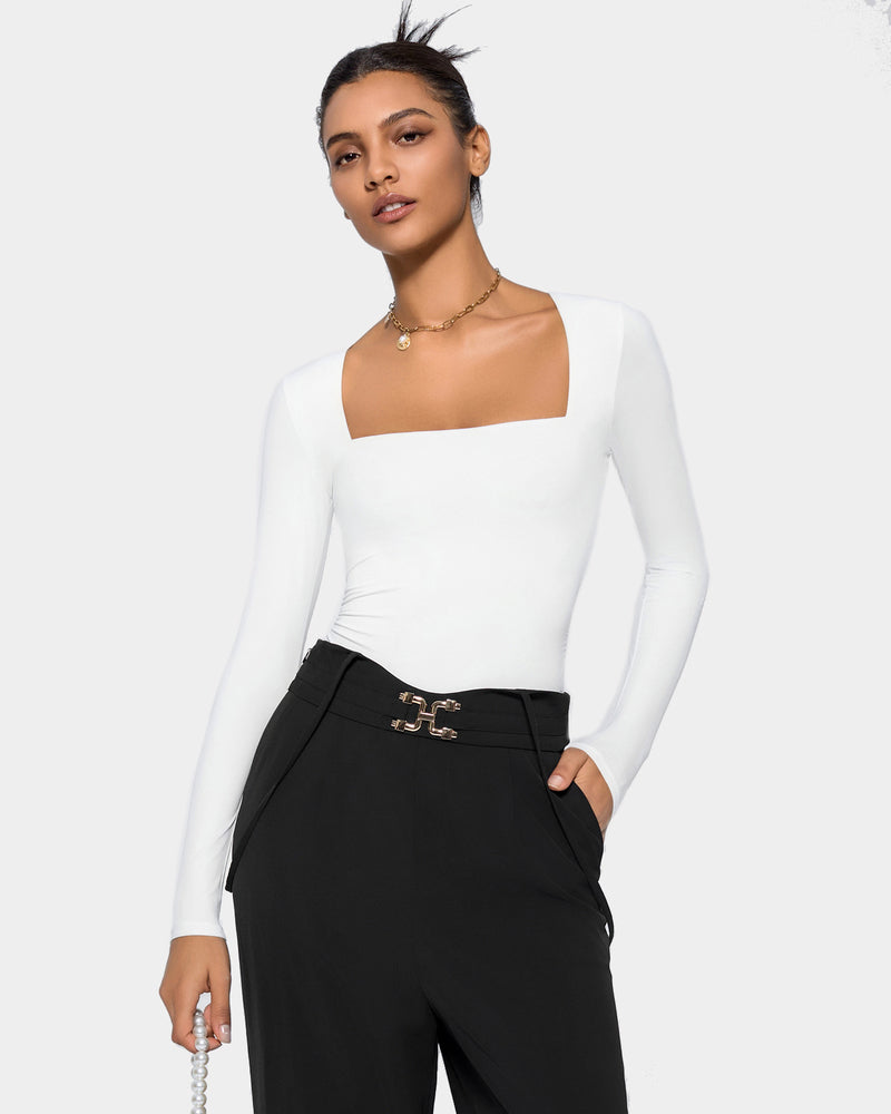 White square neck bodysuit with long sleeves, black pants. Elegant and flattering shapewear for women.