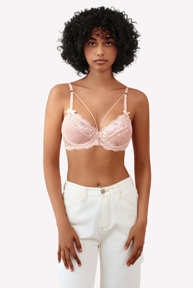 Pink lace strappy bra with underwire support and see-through design. Sexy lingerie for women.