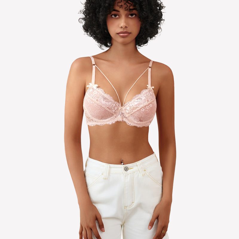 Pink lace strappy bra with underwire support and see-through design. Sexy lingerie for women.