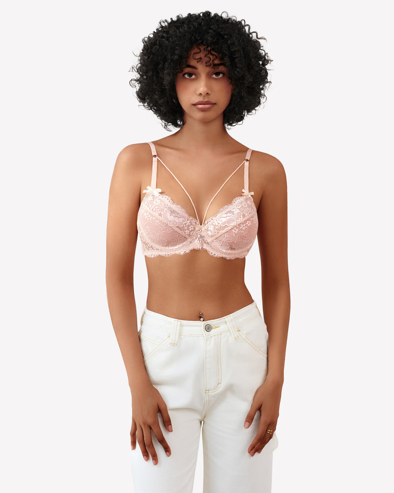 Pink lace strappy bra with underwire support and see-through design. Sexy lingerie for women.