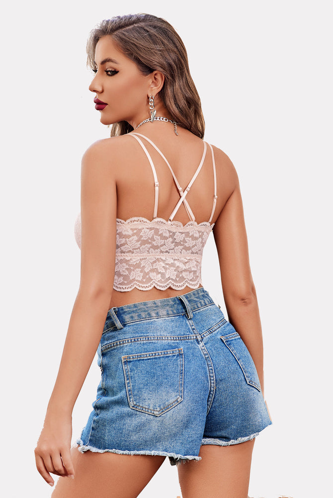 Blush pink lace crop top, adjustable straps; Y2K bralette paired with denim shorts for stylish look.