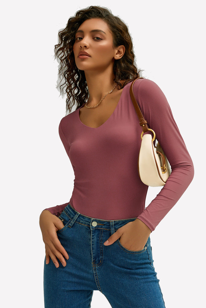 Mauve V-neck long sleeve top with jeans. Soft, stretchy fabric. Modern and stylish outfit.