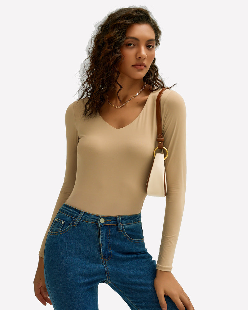Beige Y2k V-neck long sleeve top with blue jeans. Soft, stretchy fabric, stylish and modern outfit.