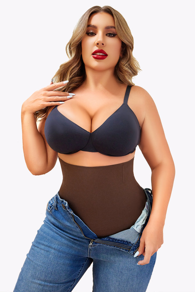 Brown tummy control shapewear with black bra and jeans, showcasing a smooth silhouette.