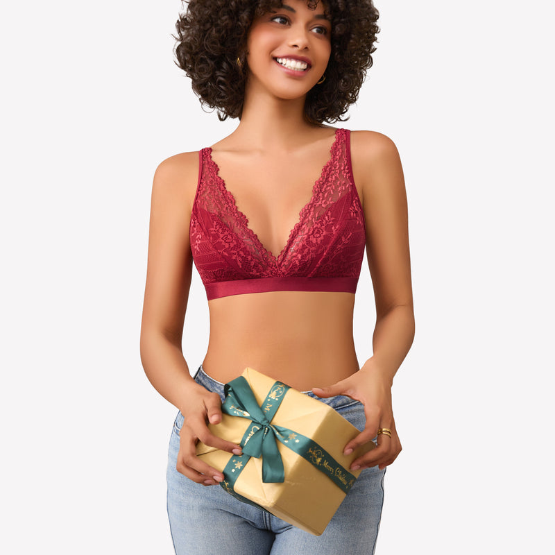 Burgundy lace bralette with adjustable straps, holding gift with Merry Christmas ribbon