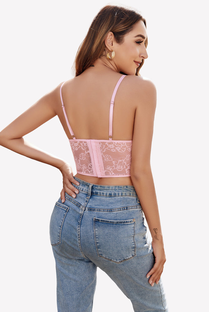 Pink lace corset top with adjustable straps, floral lace, paired with blue jeans