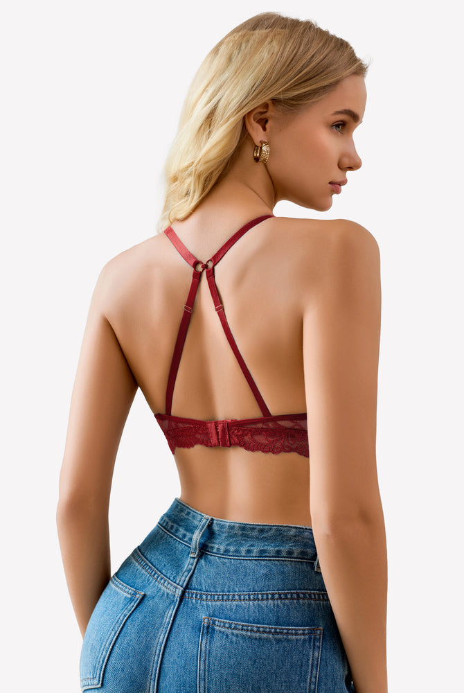 Burgundy lace bralette with adjustable straps and floral design, paired with blue denim jeans