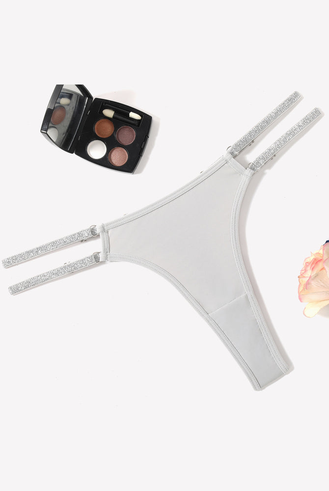 Light gray low waist Brazilian tanga panties with flashing strap details. Sexy lingerie.