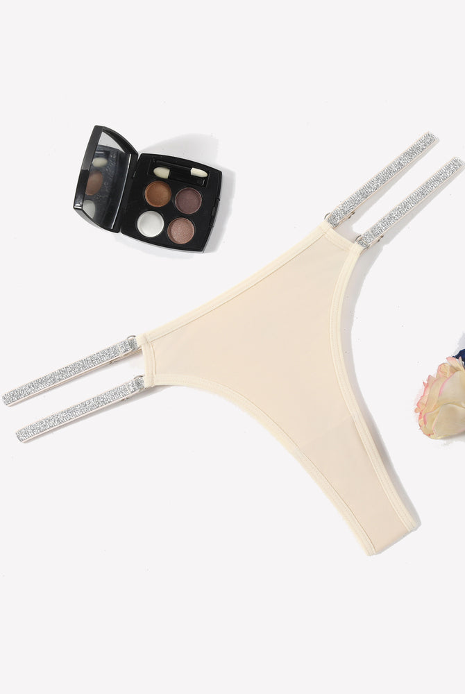 Beige low waist Brazilian tanga panties with flashing strap details. Sexy lingerie for women.