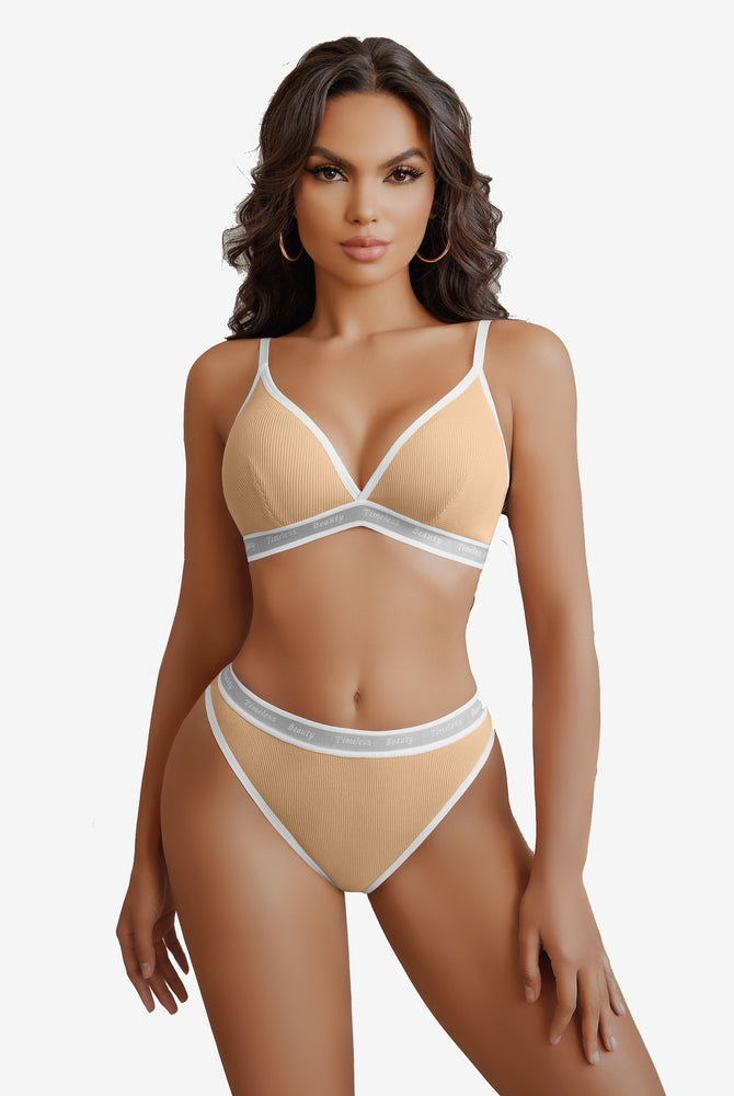 Light orange ribbed knit lingerie set with "Timeless Beauty" print, white trim, adjustable straps.