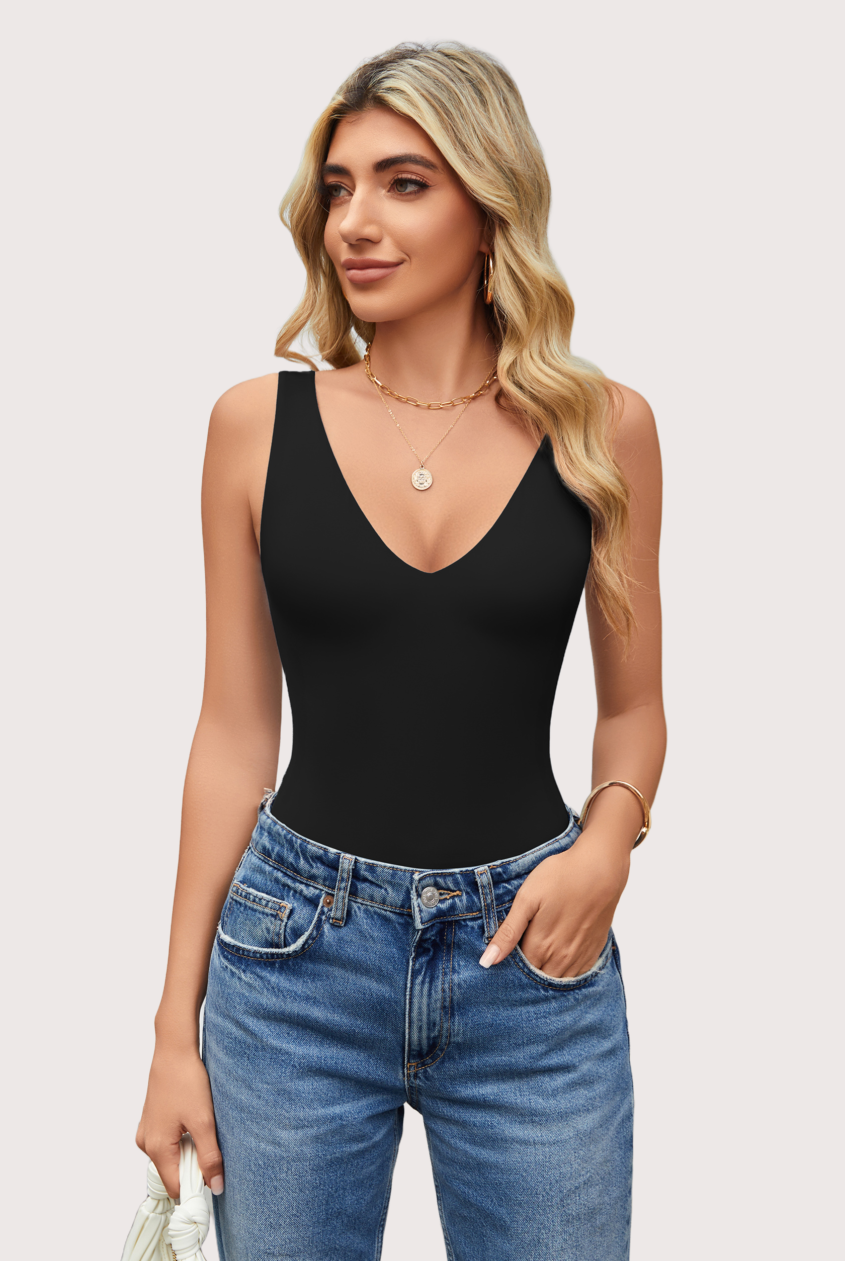 Black double-lined bodysuit leotard with plunging V-neckline and open back, paired with jeans.