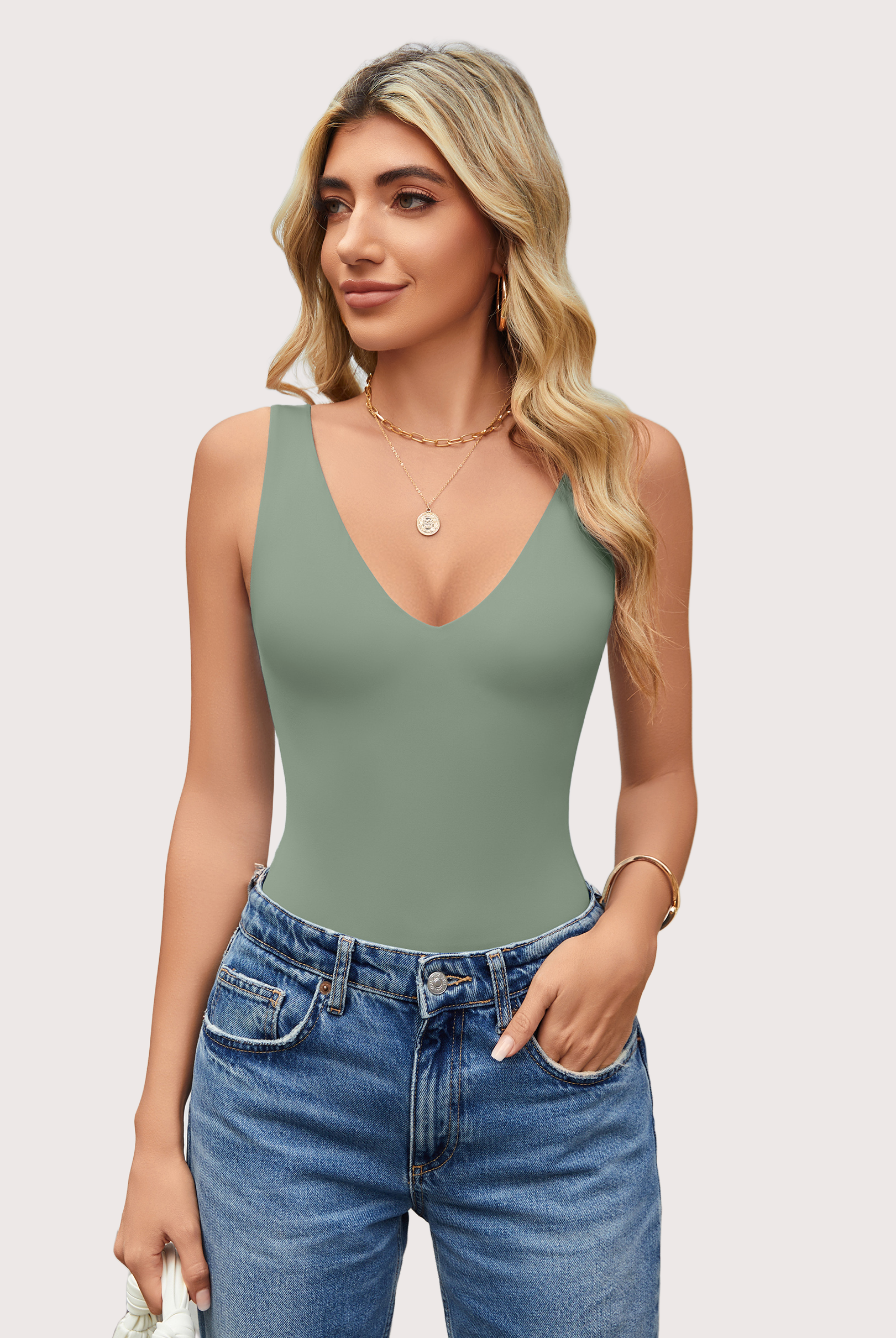 Sage green plunging V-neck bodysuit leotard with blue jeans, a must-have for your wardrobe.