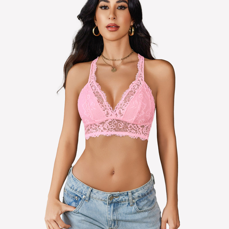 Pink lace bralette with plunging neckline and racerback, paired with jeans. Comfortable and stylish.