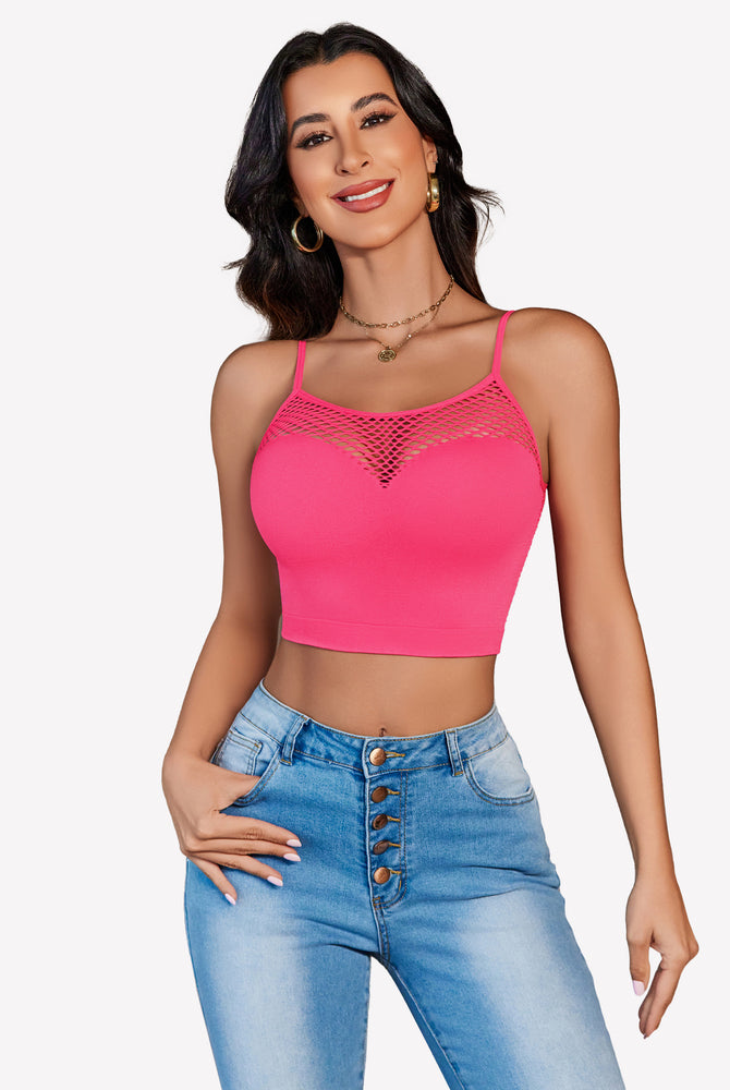 Pink fishnet crop top Y2k bralette, mesh detail, paired with jeans, showing curves.
