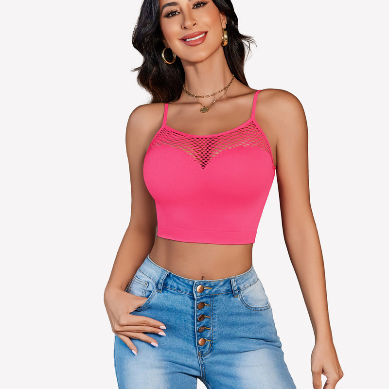 Pink fishnet crop top Y2k bralette, mesh detail, paired with jeans, showing curves.