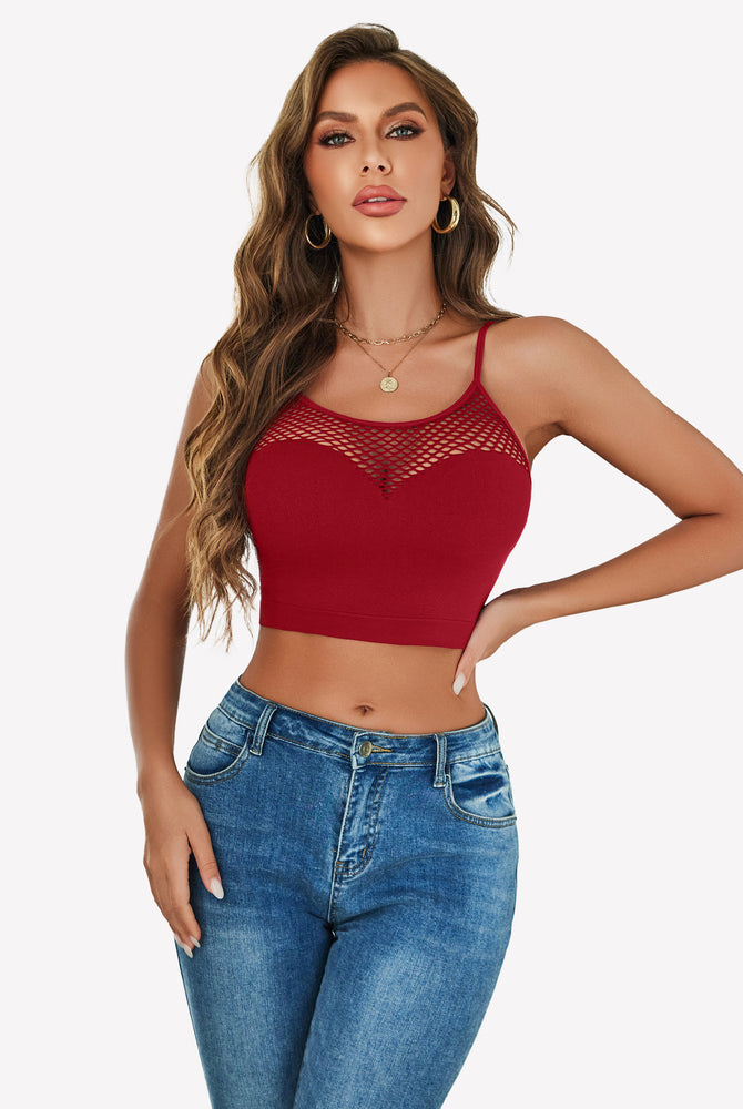 Burgundy fishnet crop top Y2k bralette with mesh detail, paired with blue jeans, showing curves.