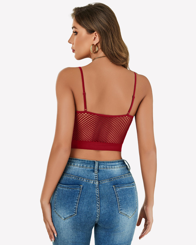 Red fishnet crop top Y2k bralette, mesh detail, paired with blue jeans, showing curves.
