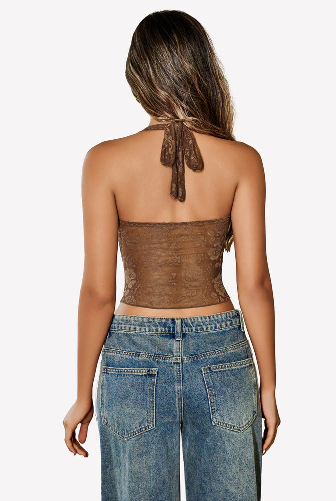 Brown lace Y2K halter top with open back, paired with jeans. Fashionable and comfortable.
