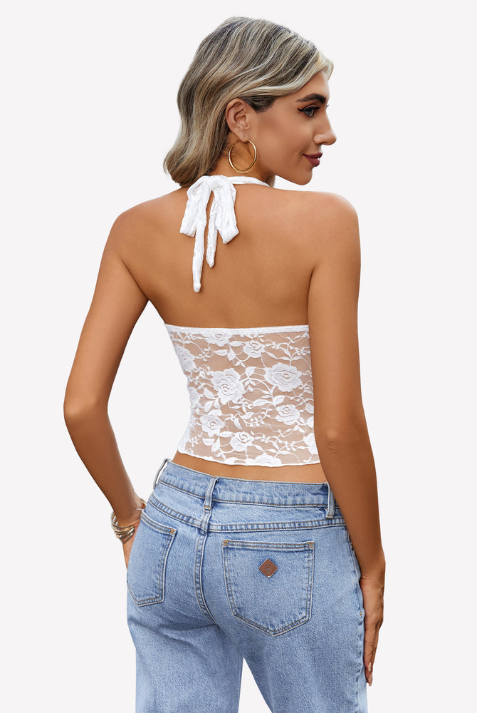 White lace Y2K halter top with open back design, paired with jeans. Fashionable and comfortable.