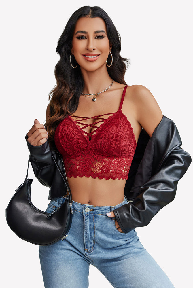 Burgundy lace Y2K camisole tank top with criss-cross straps, light-wash jeans. Floral lace detail.