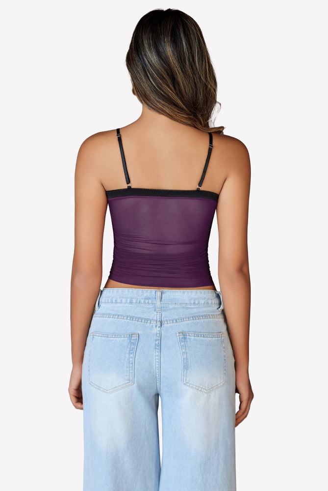 Purple ruched mesh crop top, Y2K style, with spaghetti straps and light blue jeans, back view