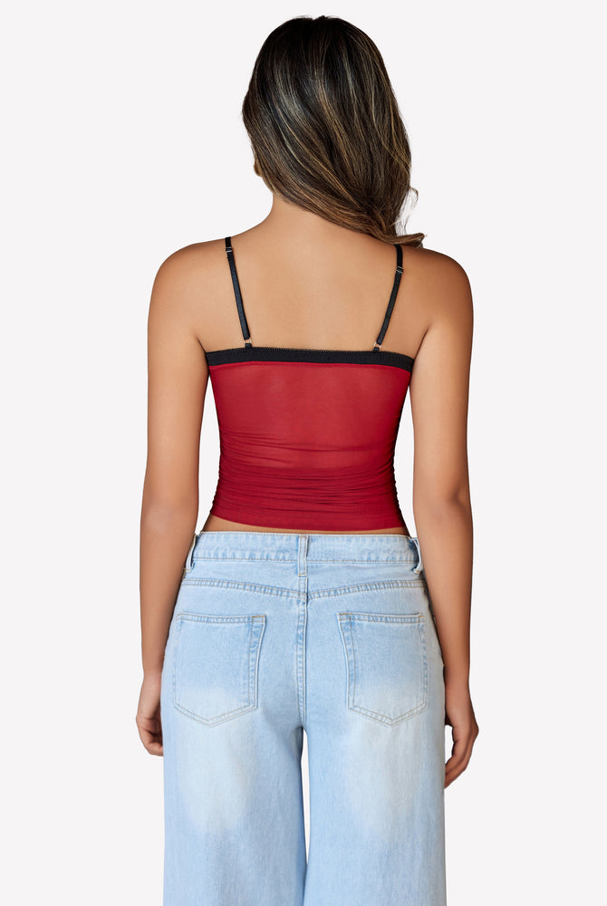 Burgundy mesh crop top with spaghetti straps, Y2K style, paired with light blue jeans