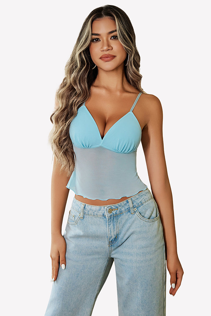 Light blue mesh crop top with adjustable straps, paired with high-waisted jeans. Y2K summer fashion.