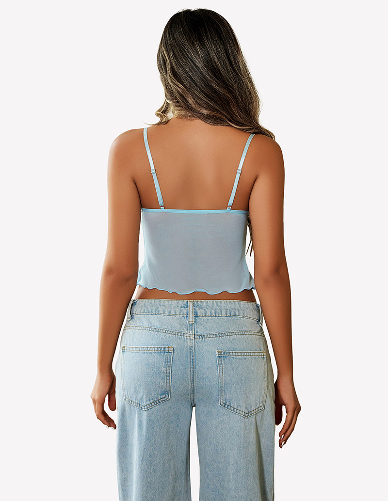 Light blue mesh crop top with adjustable straps and high-waisted jeans. Y2K summer fashion.