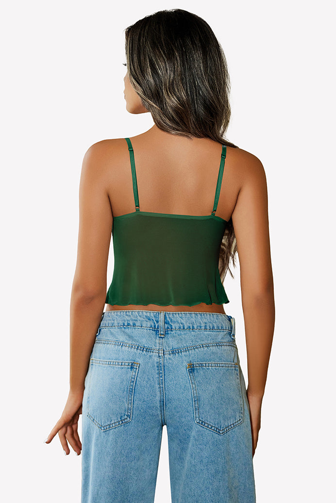 Green mesh crop top with adjustable straps and high-waisted jeans. Y2K summer fashion outfit.
