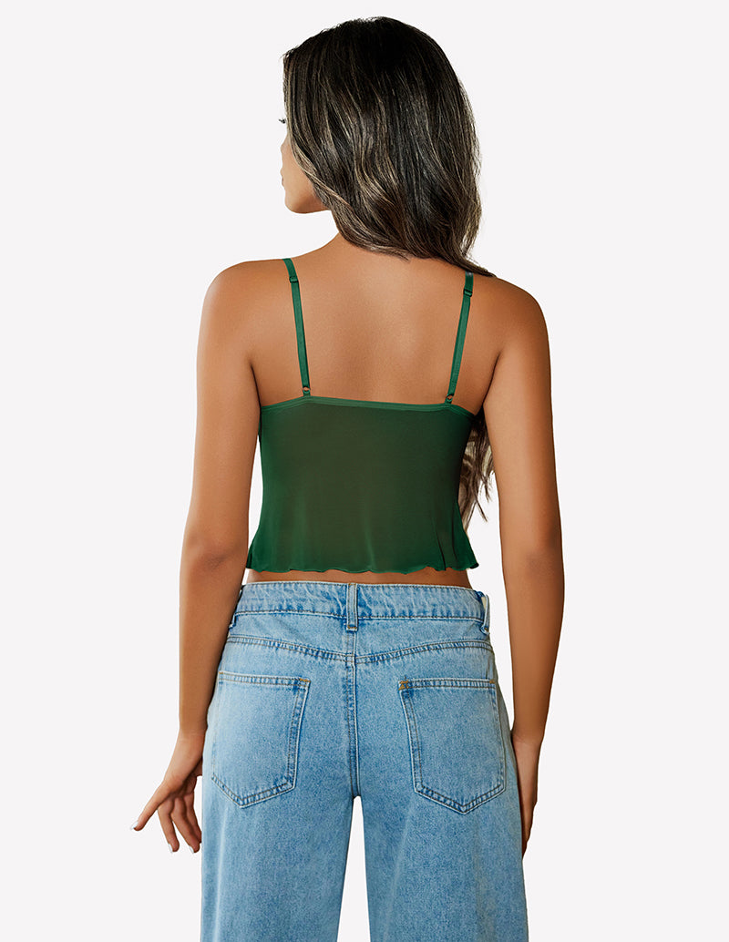 Green mesh crop top with adjustable straps and high-waisted jeans. Y2K summer fashion outfit.