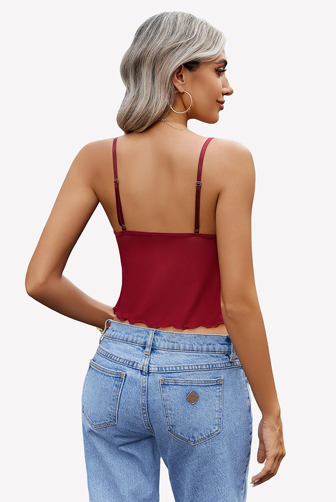 Burgundy crop top with adjustable straps and high-waisted jeans. Y2K summer fashion outfit.