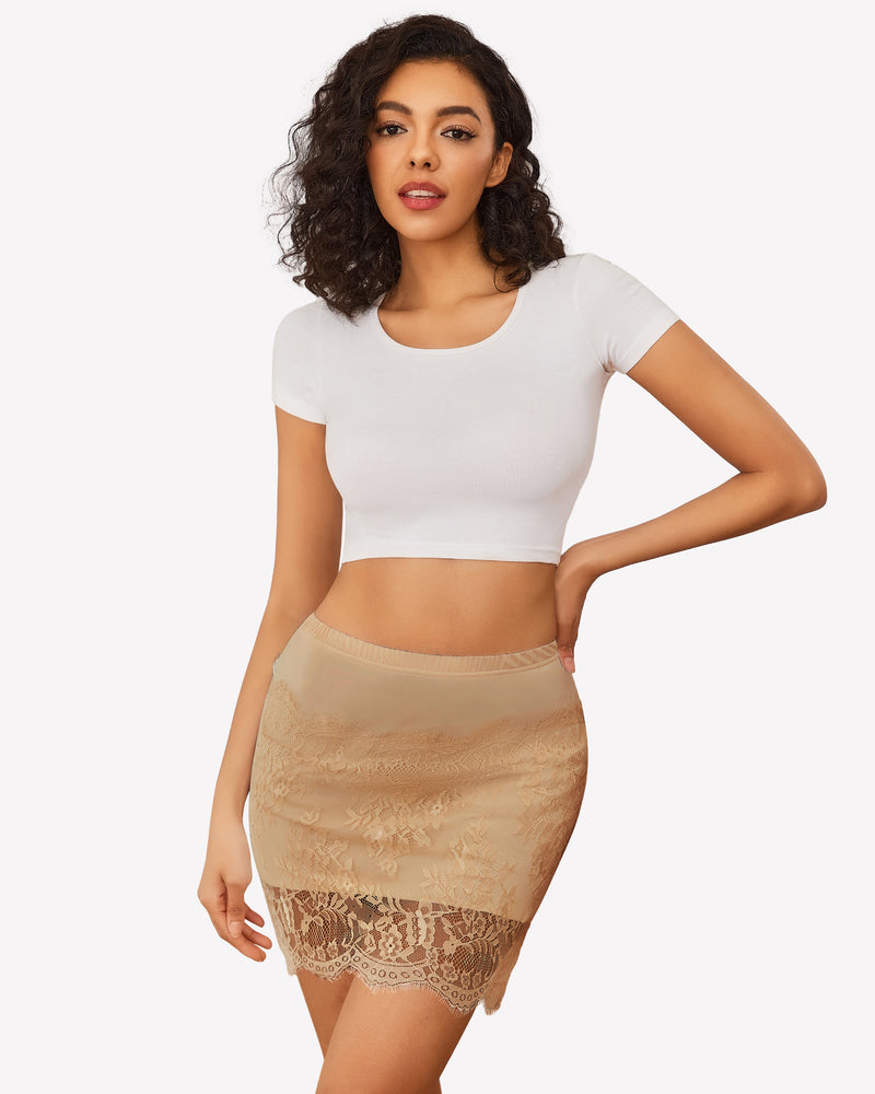 Beige lace underskirt with floral hem, paired with white crop top, comfortable and elegant fit.