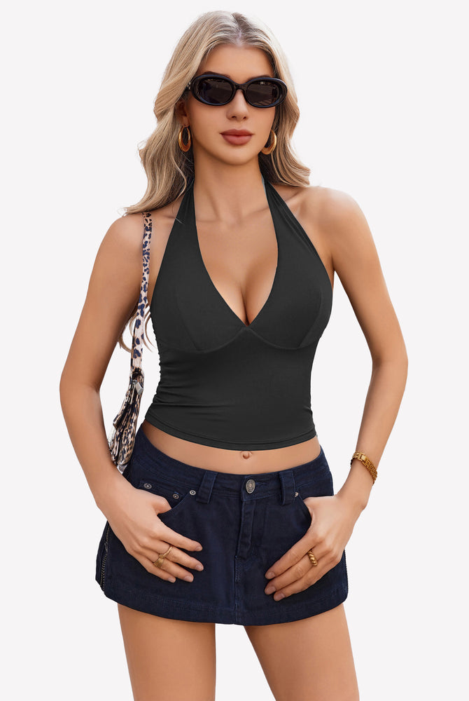 Black halter crop top with plunging V-neck. Backless design. Nylon and spandex blend.