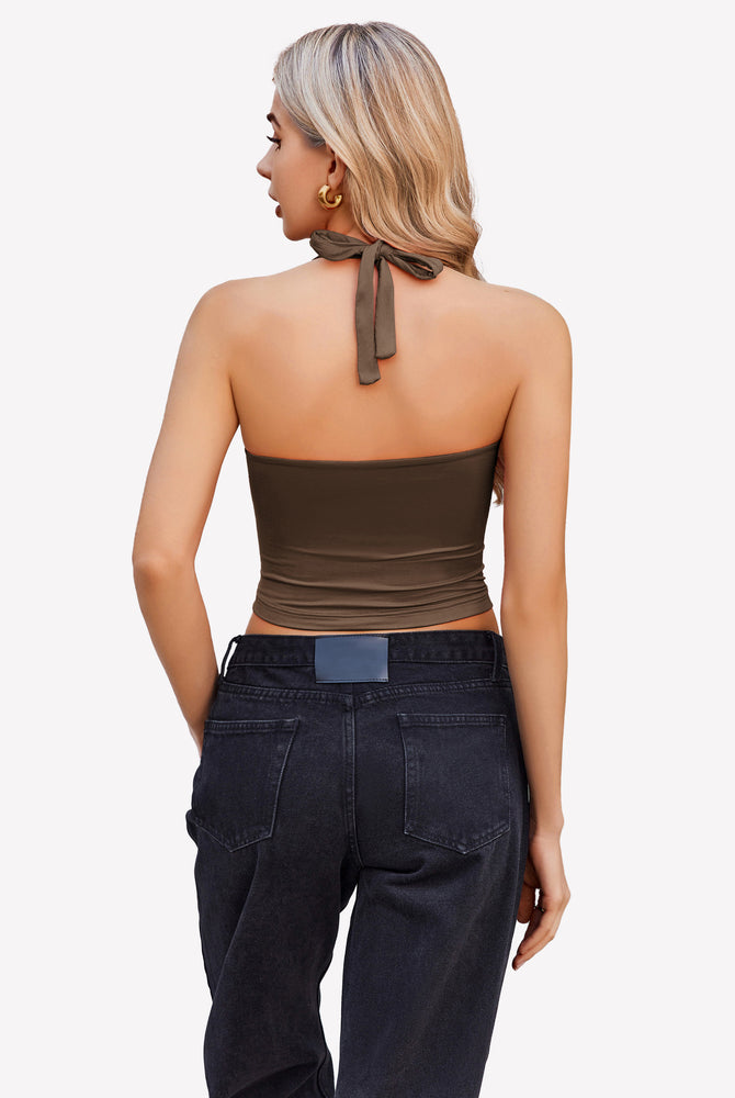 Brown halter crop top with backless design, paired with black denim jeans. Perfect for going out.