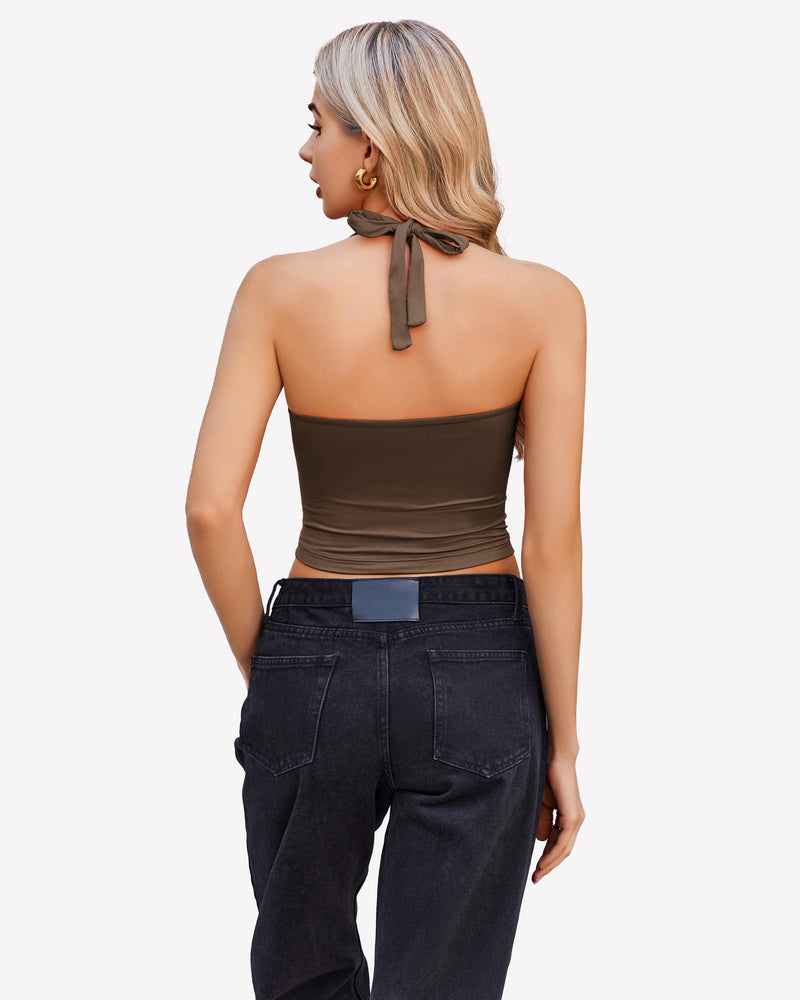 Brown halter crop top with backless design, paired with black denim jeans. Perfect for going out.