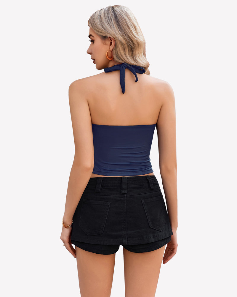 Navy blue halter crop top with backless design, paired with black denim shorts. Going out outfit.