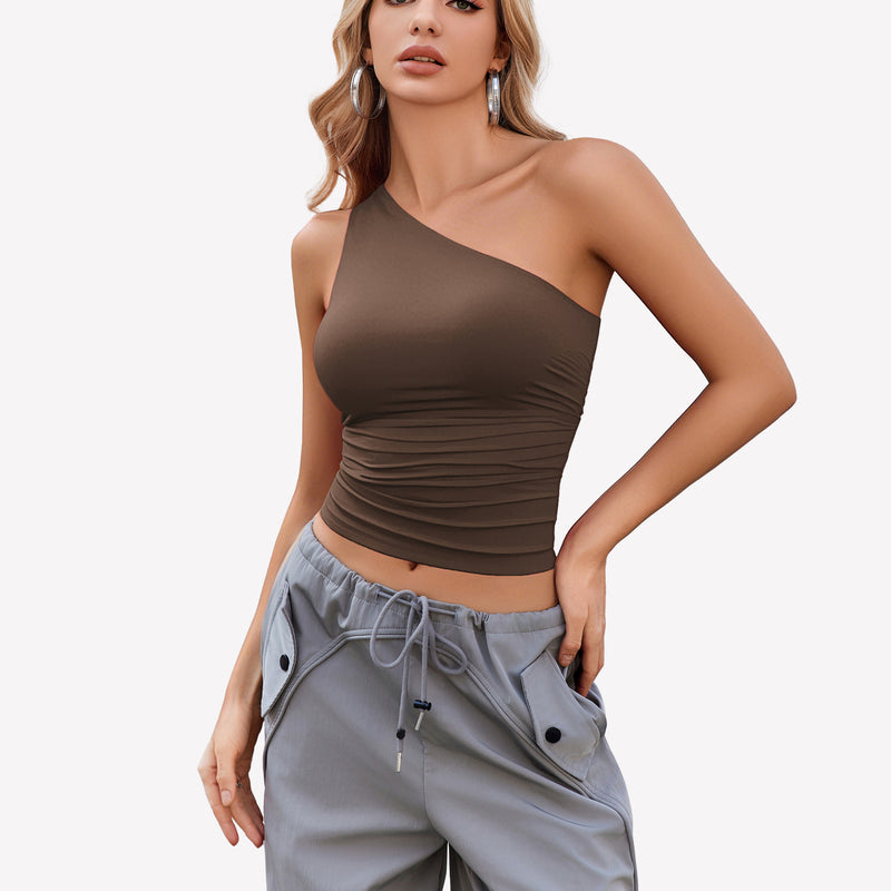 Brown one-shoulder tank top paired with gray pants, a stylish and casual look