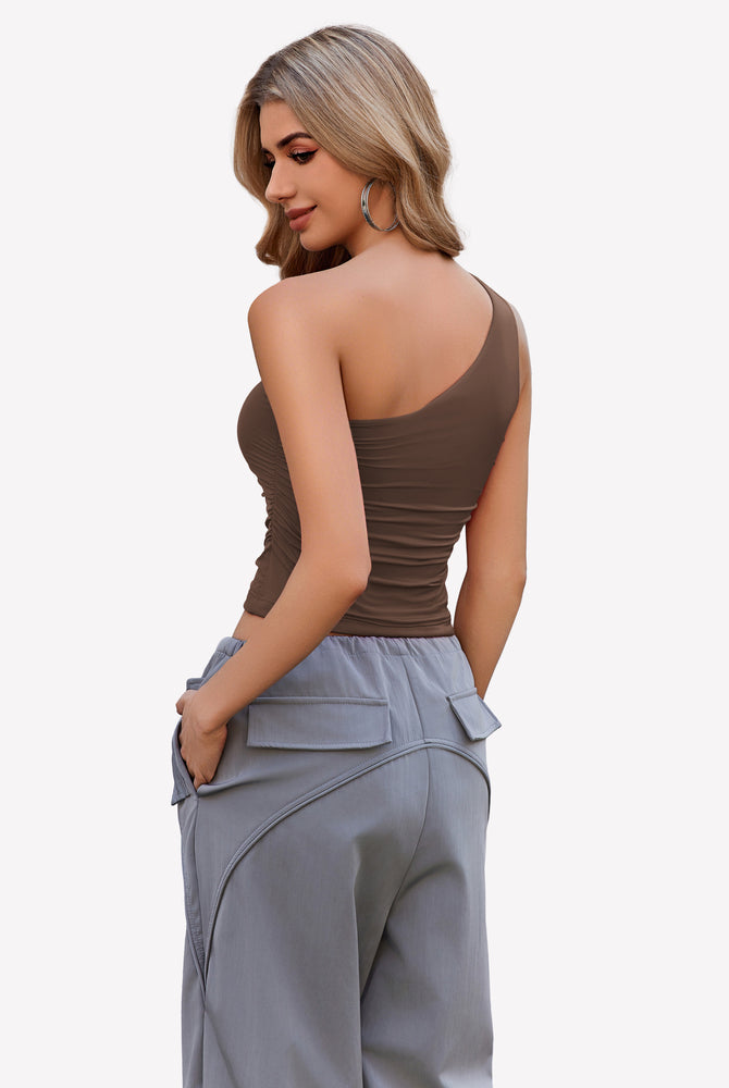 Brown one-shoulder tank top with light gray pants, a stylish and casual outfit for women