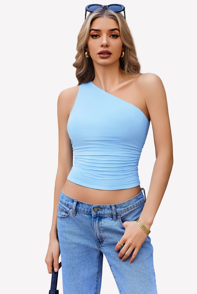 Light blue one-shoulder tank top, ruched design, paired with blue jeans. Stylish crop top.