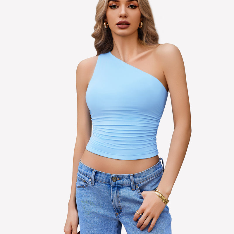 Light blue one-shoulder tank top, ruched design, paired with blue jeans. Stylish crop top.