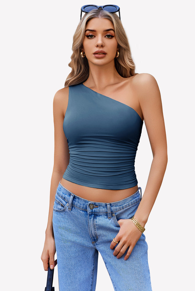 Teal one-shoulder tank top with ruched design, paired with light blue jeans. Stylish crop top.