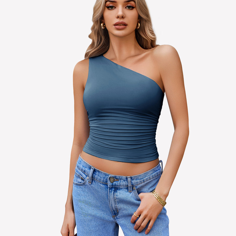 Teal one-shoulder tank top with ruched design, paired with light blue jeans. Stylish crop top.
