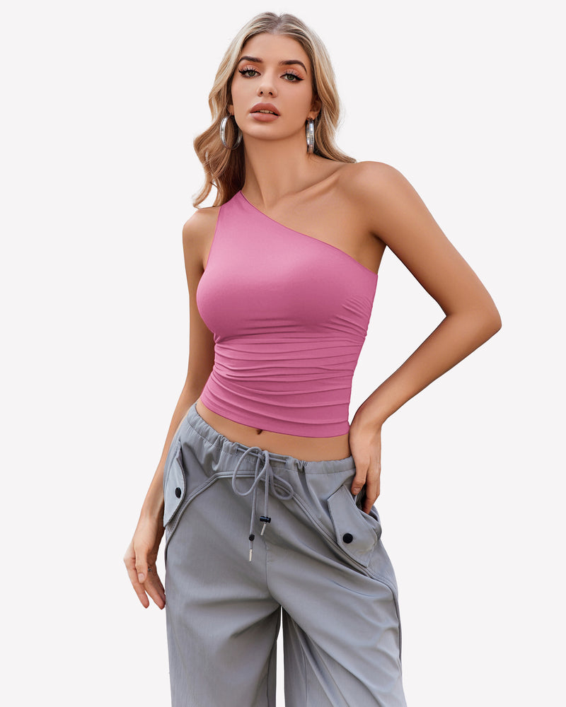 Pink one-shoulder crop top with ruched detail and gray cargo pants. Casual and stylish.