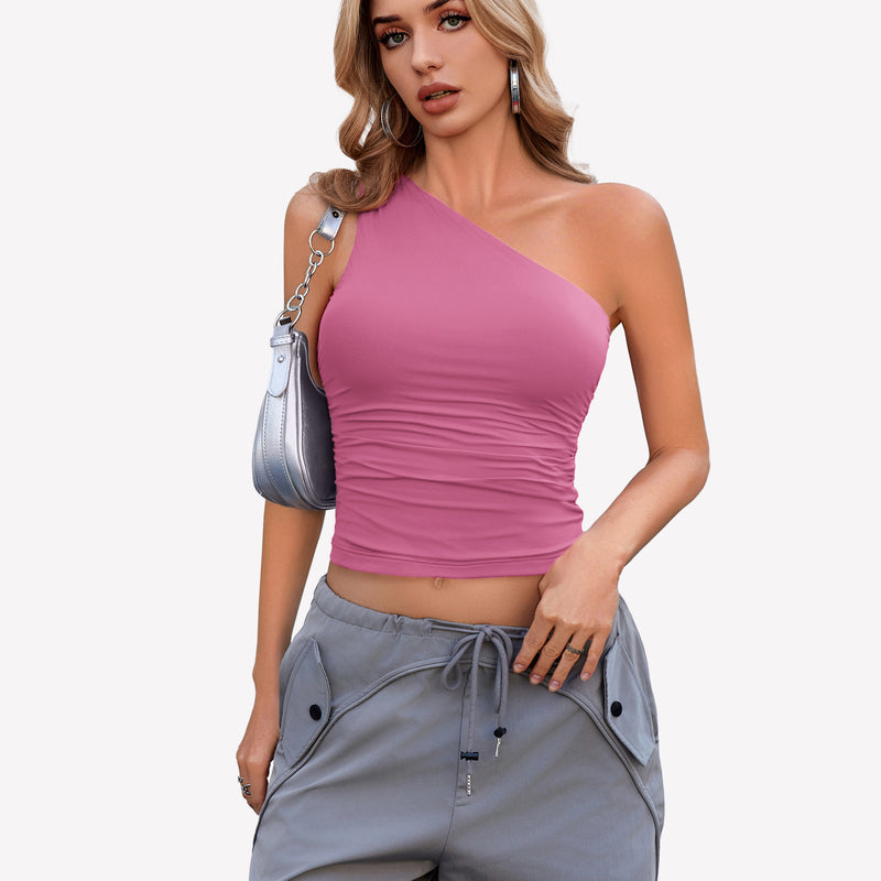 Pink one-shoulder crop top paired with gray cargo pants. Stylish and casual outfit.