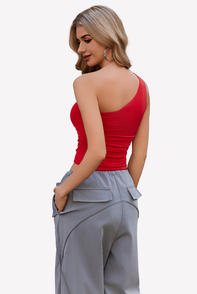 Red one-shoulder crop top and gray cargo pants. Stylish and casual outfit.