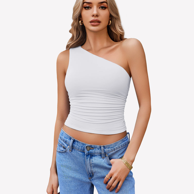 White one-shoulder crop top with ruched detail and blue jeans. Stylish and casual.