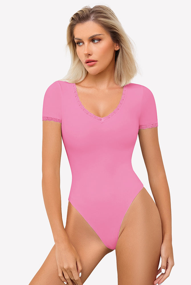 Pink V-neck bodysuit with lace trim, offering light smoothing and a flattering fit.